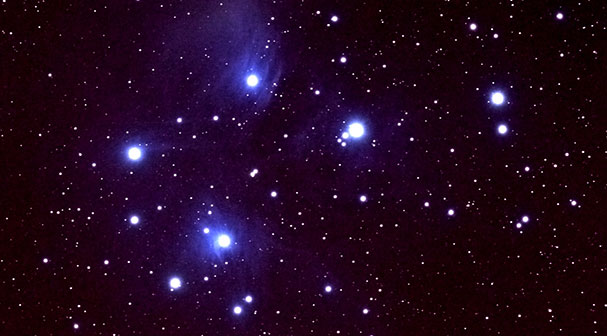 Stars with blueish haze against black sky